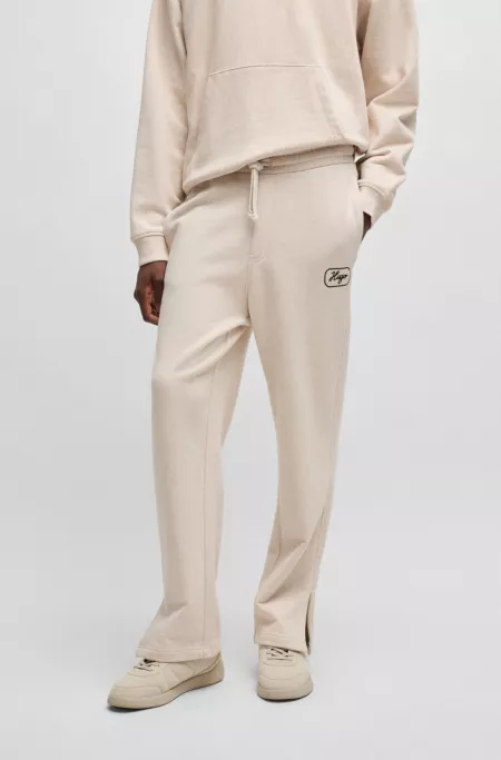 Cotton-terry tracksuit bottoms with embroidered graphics