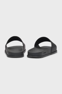 Rubber slides with debossed stacked logo, Black