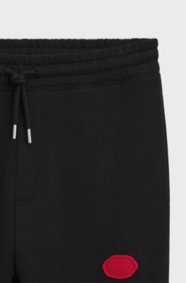 Cal&ccedil;as de fato de treino em mistura de algod&atilde;o com log&oacute;tipo em lacre, Black