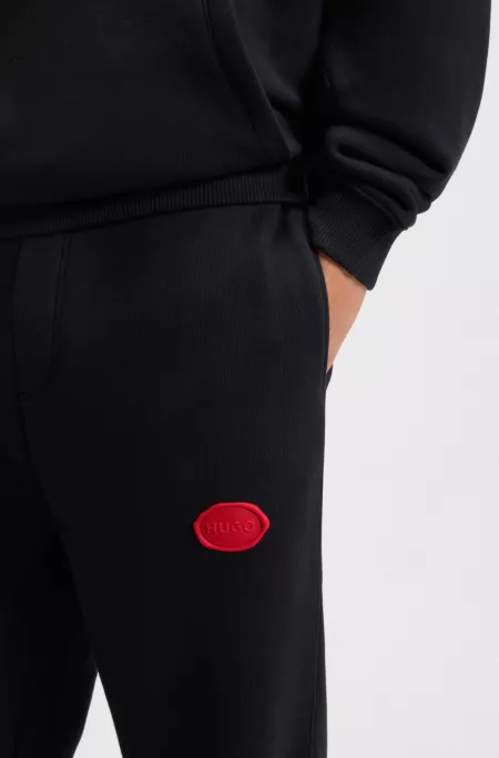 Cotton-blend tracksuit bottoms with waxed-stamp logo
