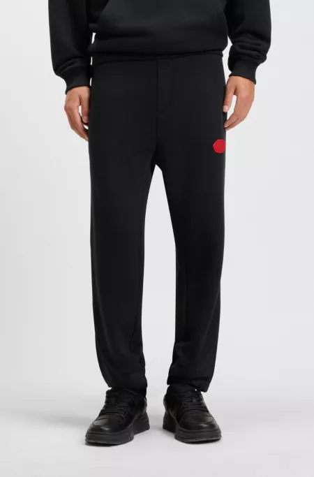 Cotton-blend tracksuit bottoms with waxed-stamp logo