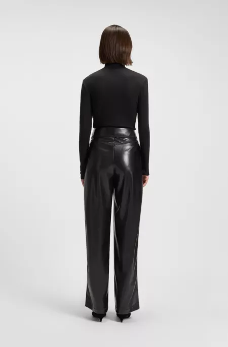 Straight-leg trousers in faux leather with belt