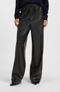 Pantalones relaxed fit de pernera ancha en piel sintética a rayas, Negro