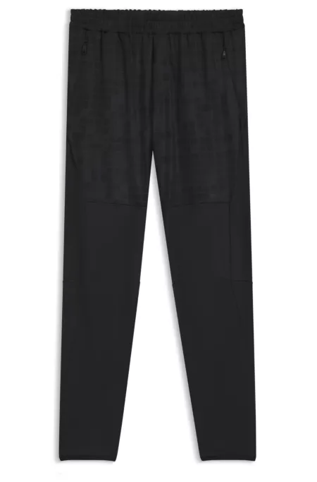 Active tracksuit bottoms in graphic-print performance fabric