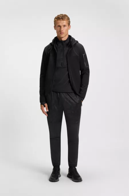 Active tracksuit bottoms in graphic-print performance fabric