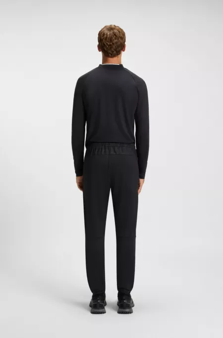 Active tracksuit bottoms in graphic-print performance fabric