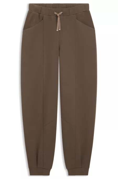 Relaxed-fit tracksuit bottoms with lustrous piping