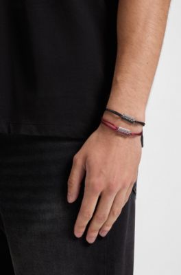 Two cord cuffs with split-logo plaques, Multicoloured