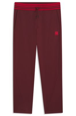 HUGO x RB oversized-fit tracksuit bottoms with striped waistband, Dark Red