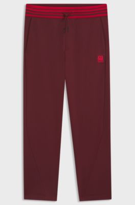 HUGO x RB oversized-fit tracksuit bottoms with striped waistband, Dark Red