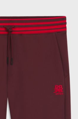 HUGO x RB oversized-fit tracksuit bottoms with striped waistband, Dark Red
