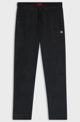 Ribbed-velvet tracksuit bottoms with stacked logo label, Black