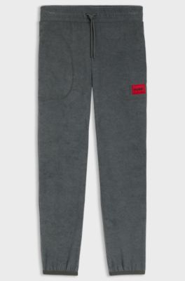 Relaxed-fit fleece tracksuit bottoms with red logo label, Dark Grey