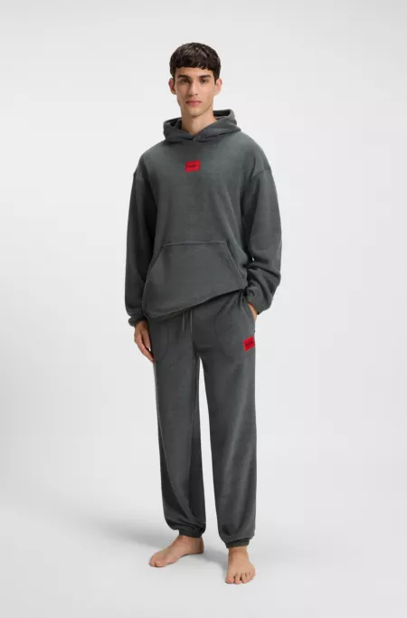 Relaxed-fit fleece tracksuit bottoms with red logo label