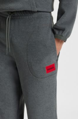 Relaxed-fit fleece tracksuit bottoms with red logo label, Dark Grey
