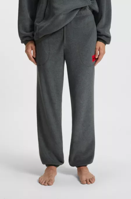 Relaxed-fit fleece tracksuit bottoms with red logo label