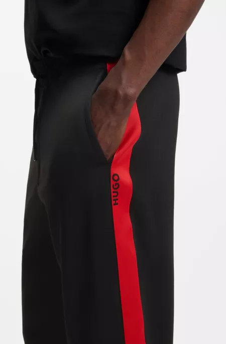 Relaxed-fit tracksuit bottoms with logo tape