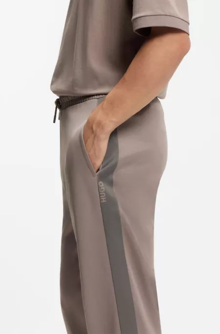 Relaxed-fit tracksuit bottoms with logo tape