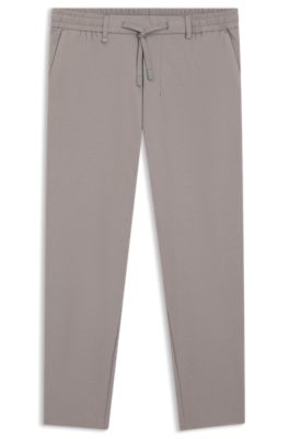 Tapered-fit trousers in waffle-structured stretch fabric, Grey