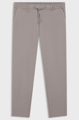 Tapered-fit trousers in waffle-structured stretch fabric, Grey