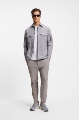 Tapered-fit trousers in waffle-structured stretch fabric, Grey