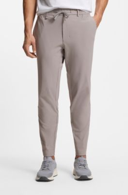 Tapered-fit trousers in waffle-structured stretch fabric, Grey