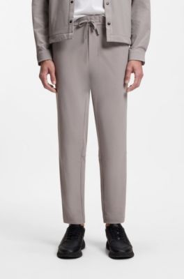 Tapered-fit trousers in waffle-structured stretch fabric, Grey
