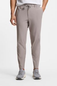 Tapered-fit trousers in waffle-structured stretch fabric, Grey