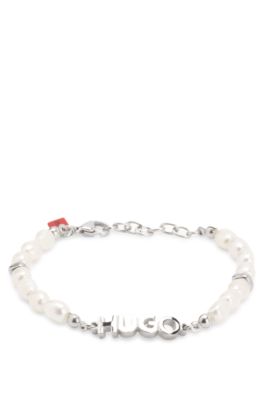 Pearl cuff with metal logo plaque, Silver tone