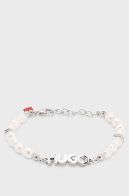 Pearl cuff with metal logo plaque, Silver tone
