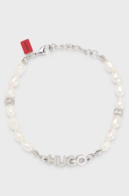 Pearl cuff with metal logo plaque, Silver tone