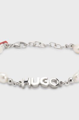 Pearl cuff with metal logo plaque, Silver tone