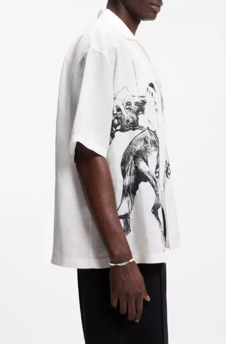 Pearl cuff with metal logo plaque