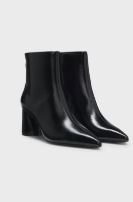 Ankle boots in leather with embossed logo, Black