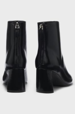 Ankle boots in leather with embossed logo, Black