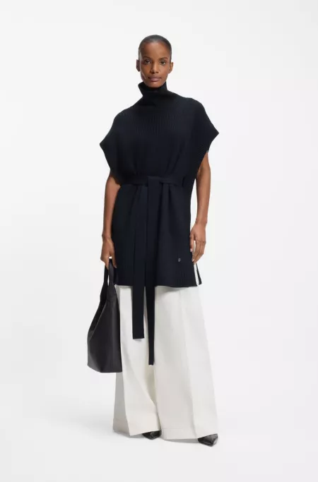 Knitted poncho in virgin wool with high neckline