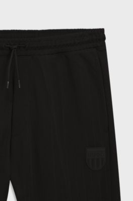 Jogginghose aus Baumwoll-Mix mit Drop-Needle-Streifen, Schwarz