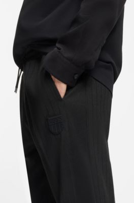 Cotton-blend tracksuit bottoms with drop-needle stripe, Black