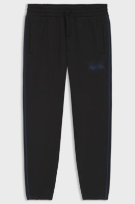 Trainingsbroek van katoenen sweatstof met logo en contrasterende stiksels, Zwart