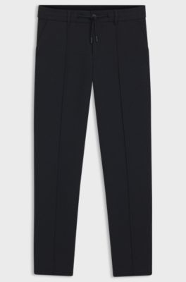 Tapered fit-byxor i performance stretch-tyg, M&ouml;rkbl&aring;