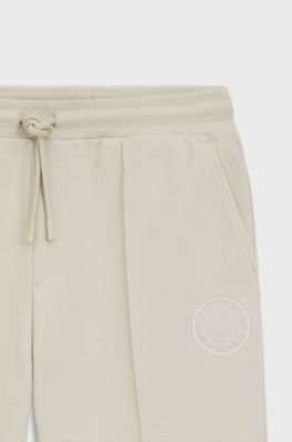 Cotton-blend tracksuit bottoms with tennis-themed logo, Natural
