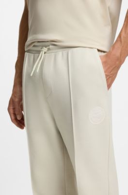 Cotton-blend tracksuit bottoms with tennis-themed logo, Natural