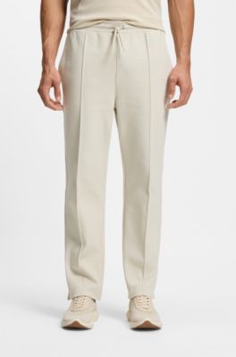 Cotton-blend tracksuit bottoms with tennis-themed logo, Natural