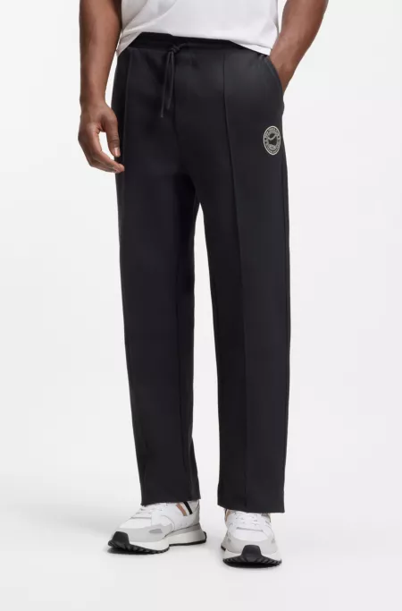 Cotton-blend tracksuit bottoms with tennis-themed logo