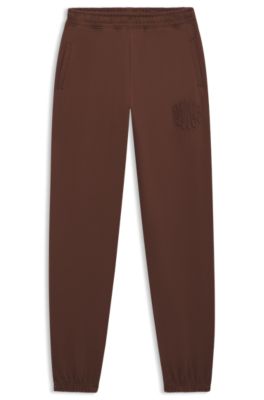 Loose-fit cotton-terry tracksuit bottoms with logo artwork, Brown