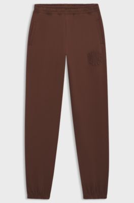 Losvallende trainingsbroek van katoenen badstof met logo-artwork, Bruin