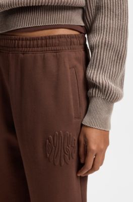 Loose-fit cotton-terry tracksuit bottoms with logo artwork, Brown