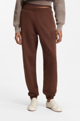 Loose-fit cotton-terry tracksuit bottoms with logo artwork, Brown
