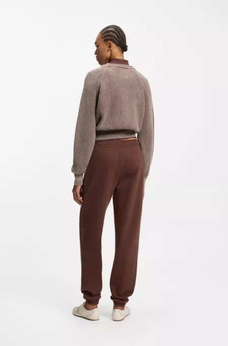 Pantalones de chándal loose fit de felpa de algodón con ilustración de logo