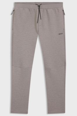 Pantalones de ch&aacute;ndal regular fit con detalles reflectantes, Gris